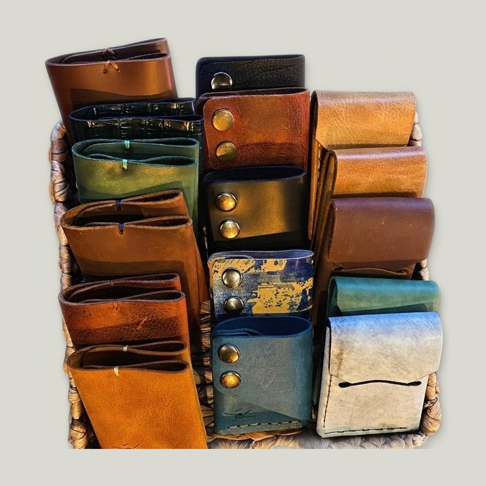 a basket full of handmade leather wallets in many colours